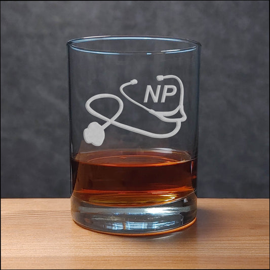 Nurse Practitioner Whiskey Glass with a etched image of a Stethoscope and the designation letters N P on  it - Copyright Hues in Glass