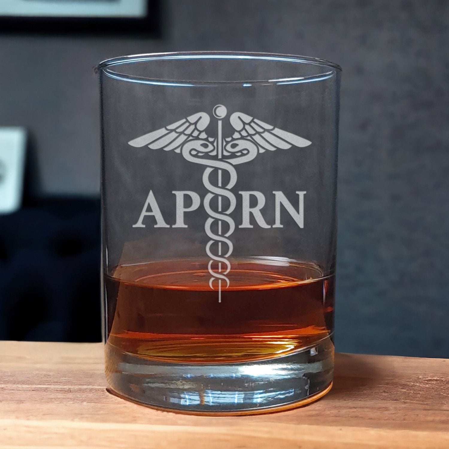 Doctor of Osteopathic Medicine Whiskey Glass with a etched image of a Caduceus and the designation letters A P R N on either side of it - Copyright Hues in Glass