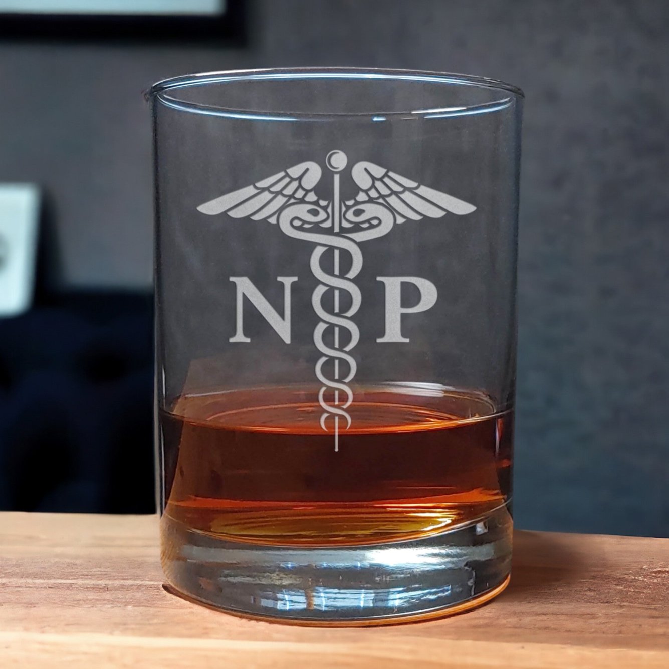 Registered Nurse Whiskey Glass with a etched image of a Caduceus and the designation letters R N on either side of it - Copyright Hues in Glass
