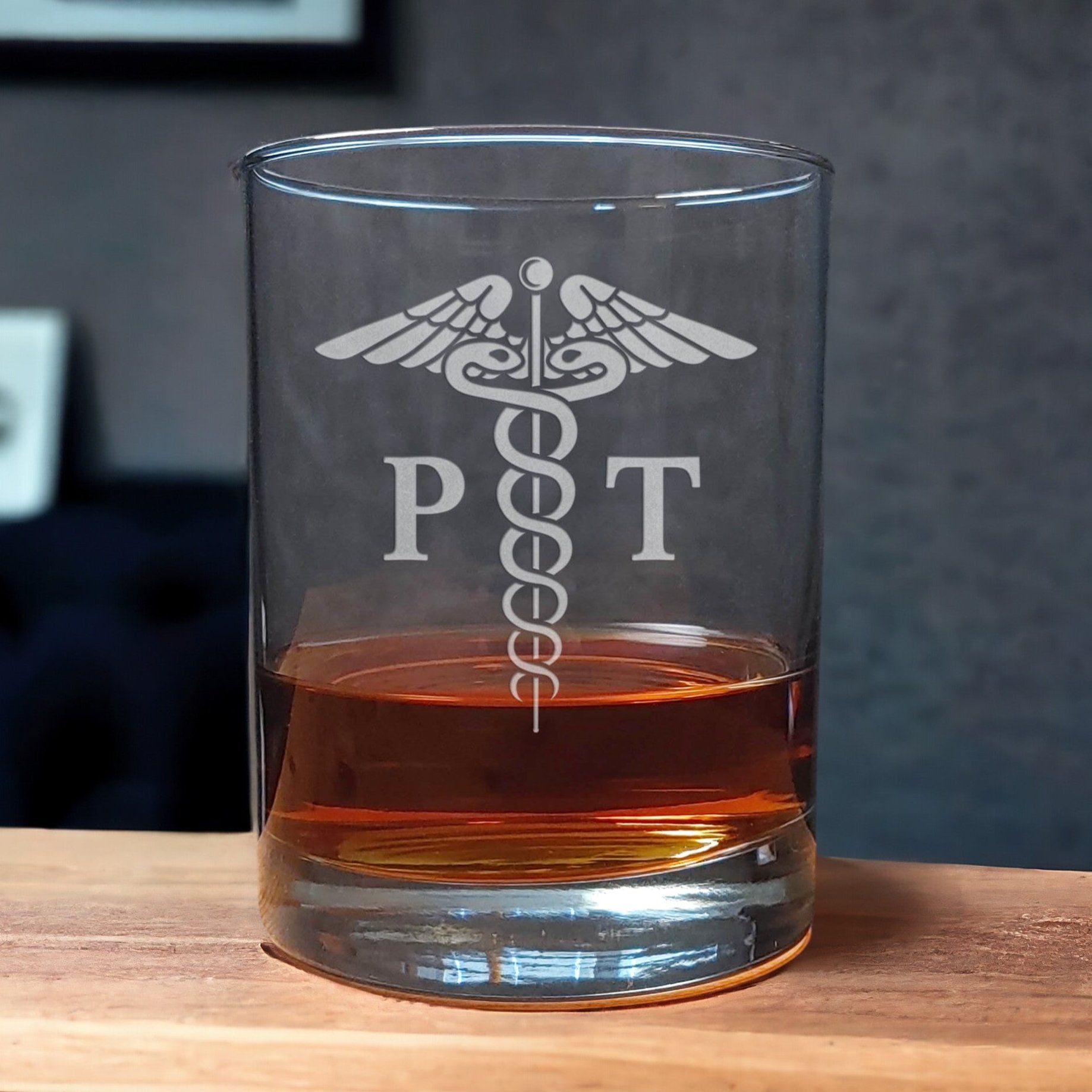 Physical Therapist Whiskey Glass with a etched image of a Caduceus and the designation letters P T on either side of it - Copyright Hues in Glass