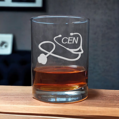 Certified Emergency Nurse Whiskey Glass with a etched image of a Stethoscope and the designation letters C E N on  it - Copyright Hues in Glass