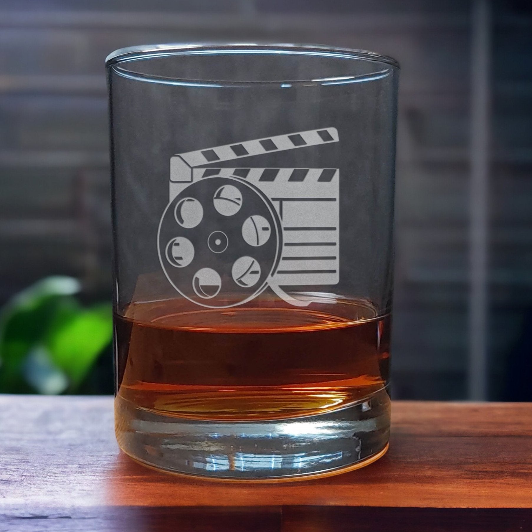 13oz Whiskey Glass with an etched image of a film reel and clapper - Copyright Hues in Glass