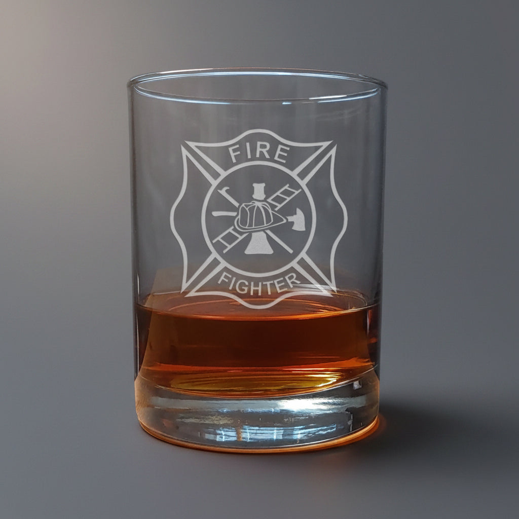 Glass tumbler with 'Fire Fighter' emblem filled with amber liquid