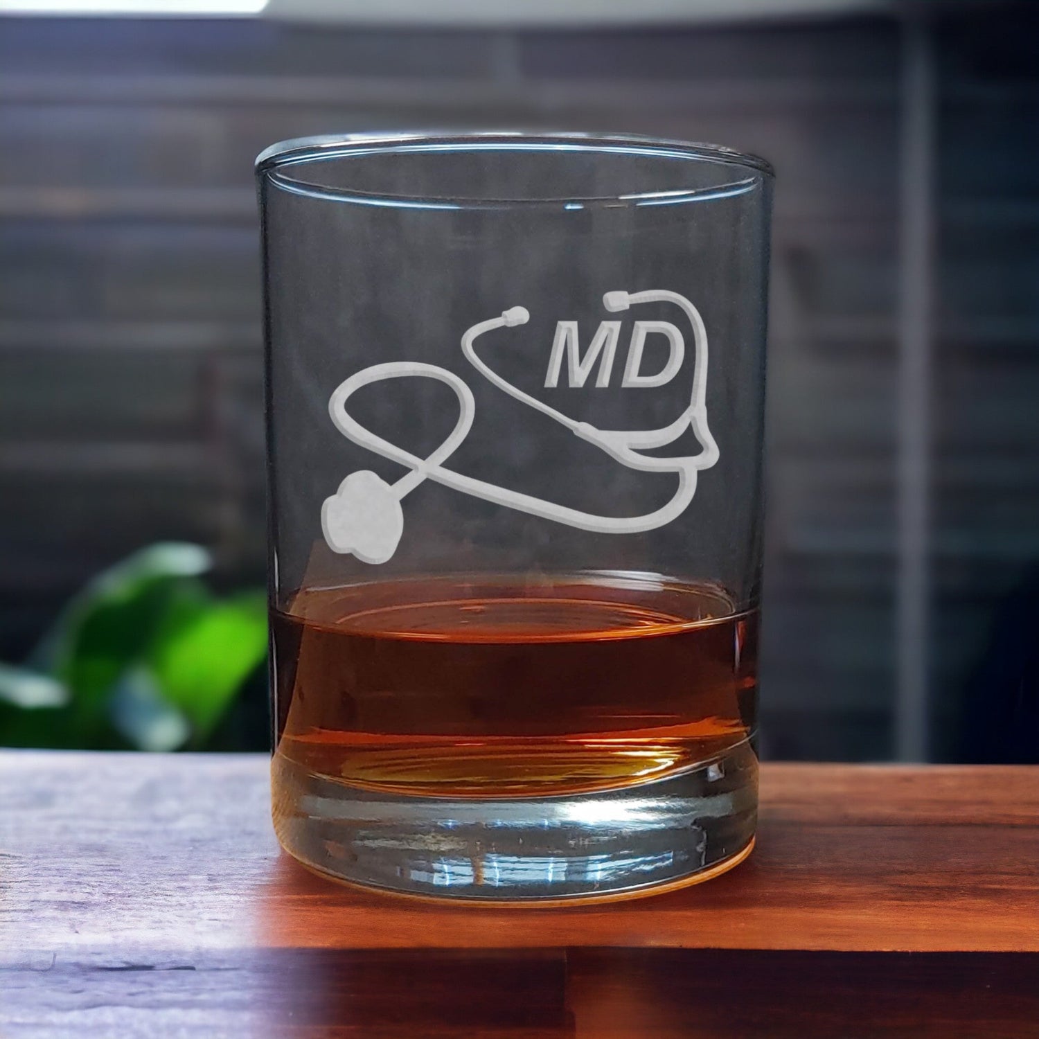 Medical Doctor Whiskey Glass with a etched image of a Stethoscope and the designation letters M D on  it - Copyright Hues in Glass