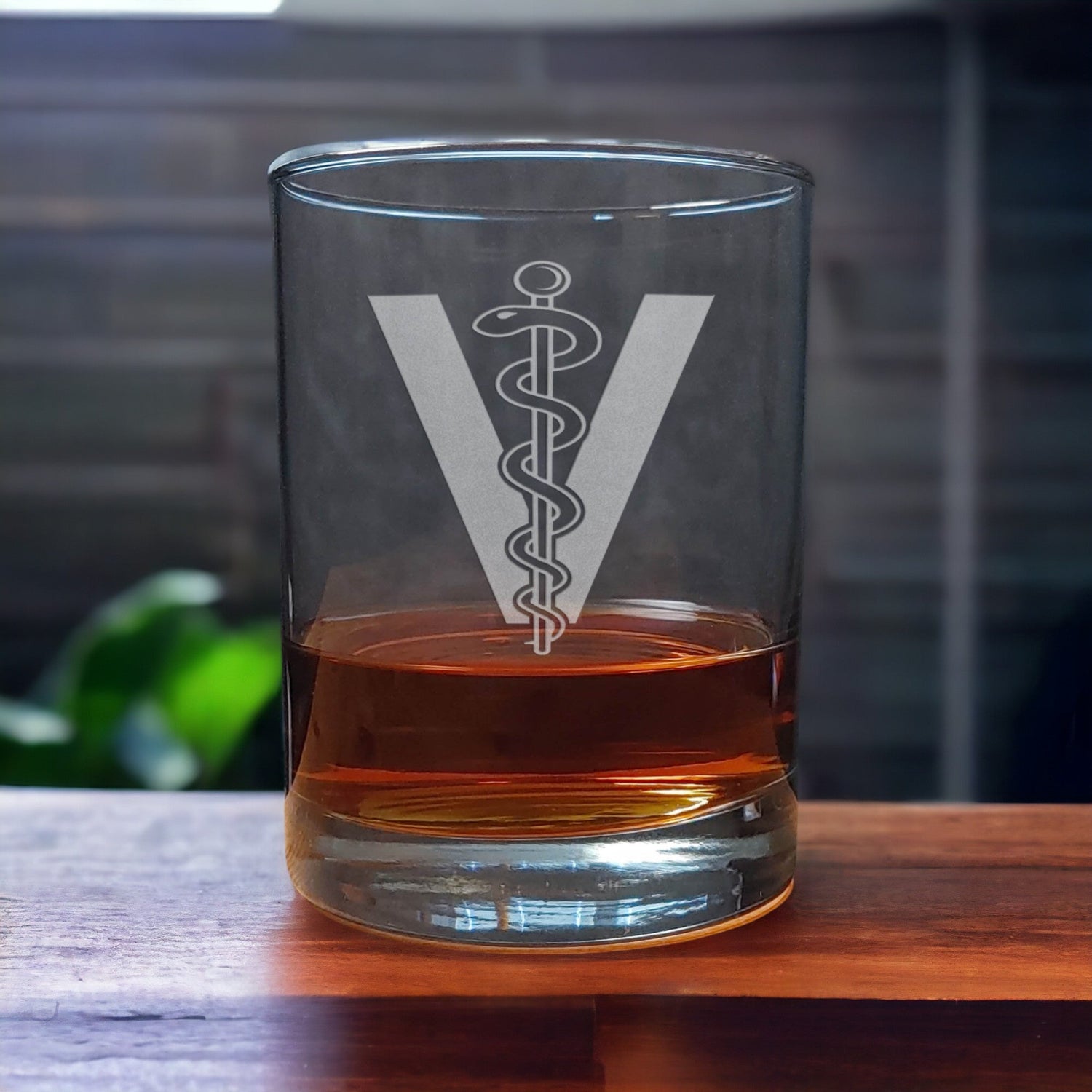 Whiskey Glass with a etched image of the veterinarian insignia - Copyright Hues in Glass