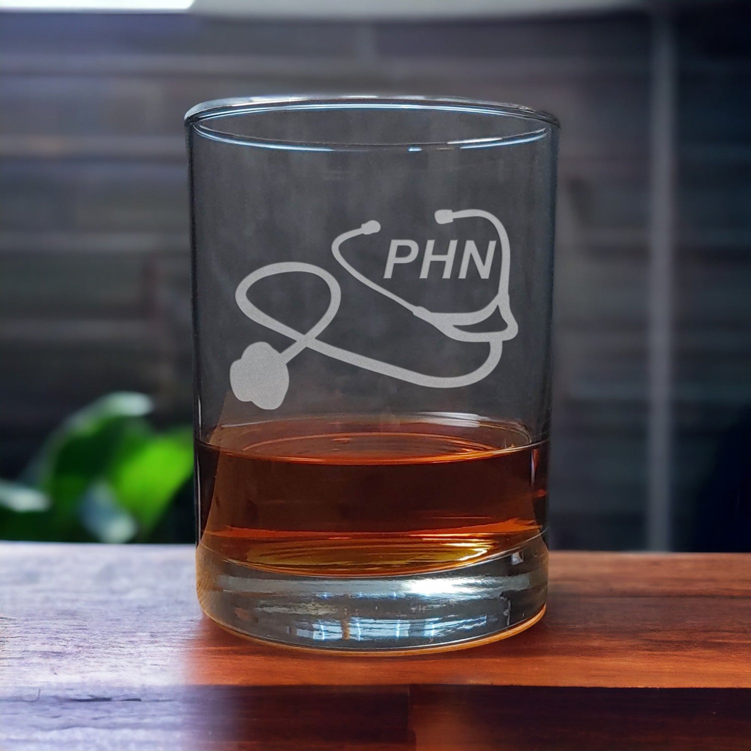 Public Health Nurse Whiskey Glass with a etched image of a Stethoscope and the designation letters P H N on  it - Copyright Hues in Glass
