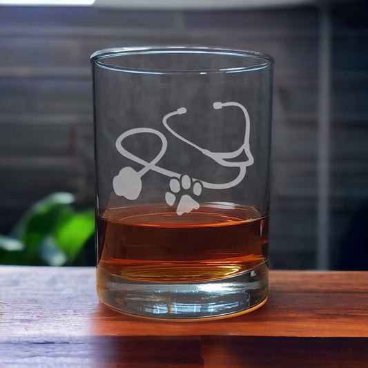 Whiskey Glass with a etched image of a Stethoscope and a paw print - Copyright Hues in Glass