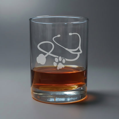 Clear glass with a stethoscope design with a paw filled with amber liquid 