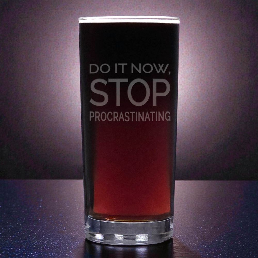 Glass with red liquid and motivational text on a dark background