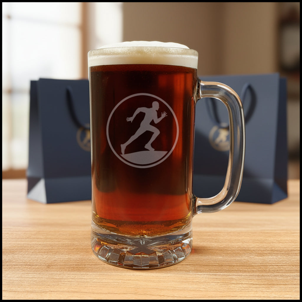 A clear glass beer mug filled with dark amber beer and topped with white foam, standing on a light wood surface. The mug has an  etched running-man silhouette image on the front.