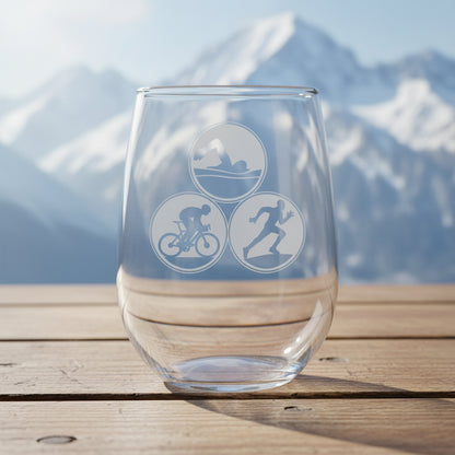 Clear glass with triathlon symbols on a wooden surface