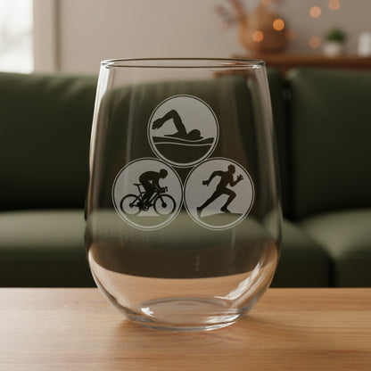 Clear glass with triathlon symbols on a wooden surface