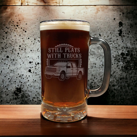 Beer mug etched with a truck and the words Still Plays With Trucks aginst a textured background