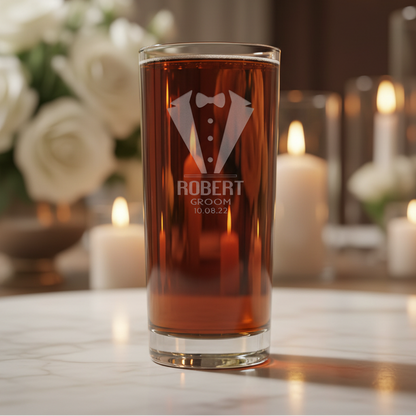 Glass with tuxedo design and "ROBERT - GROOM - DATE"  engraved the glass - with wedding roses and candles in the background
