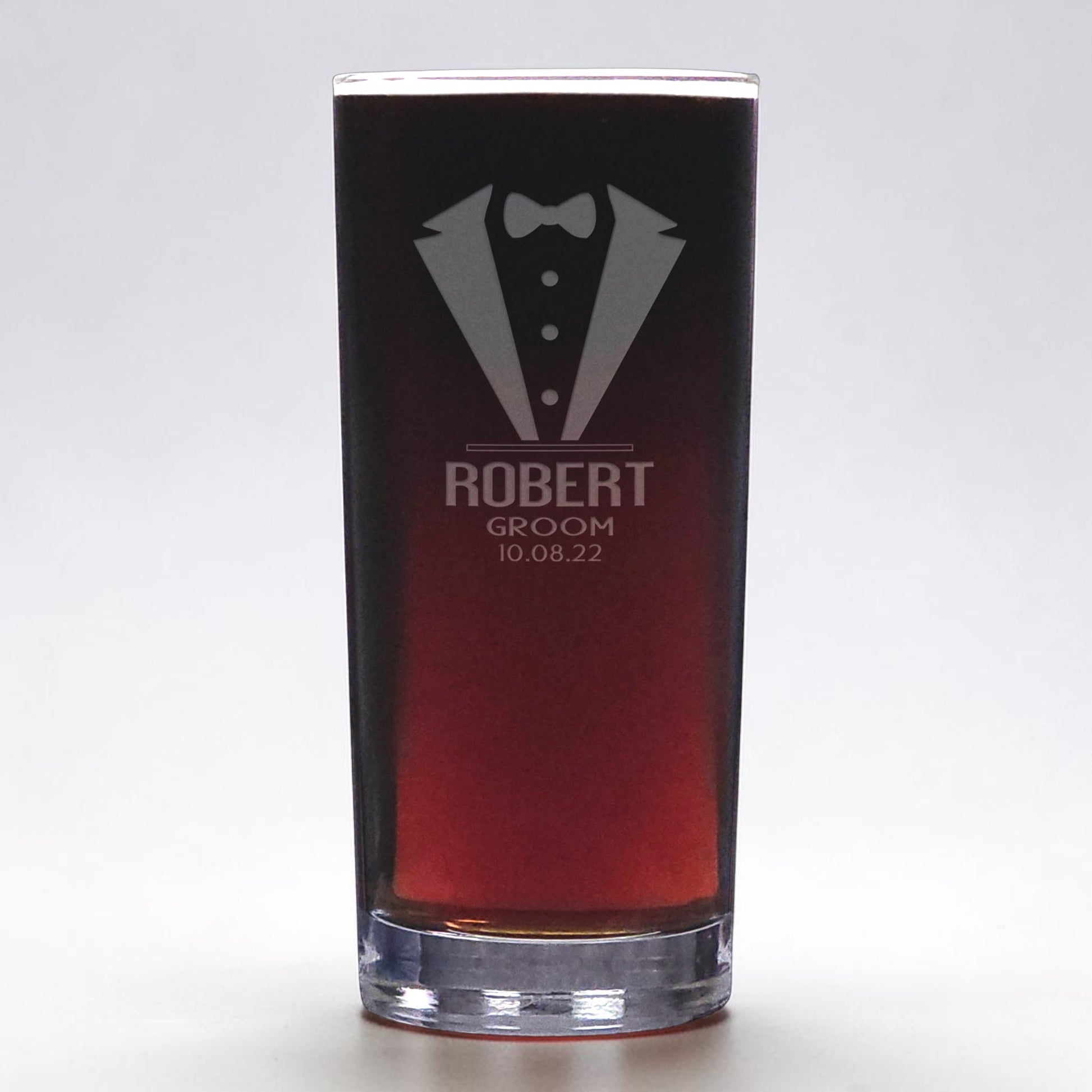 Glass with tuxedo design and text on a white background