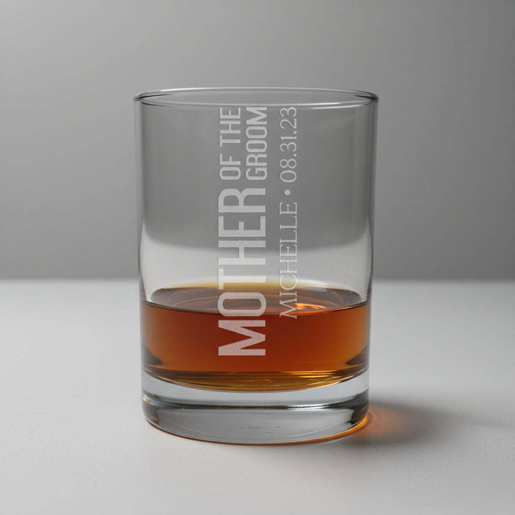 Glass tumbler with engraved text on a wooden surface and gray background