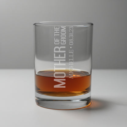 Glass tumbler with engraved text on a wooden surface and gray background