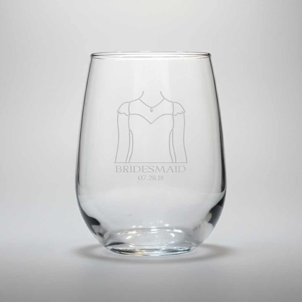 Clear glass with engraved design of a wedding dress and text on a white background