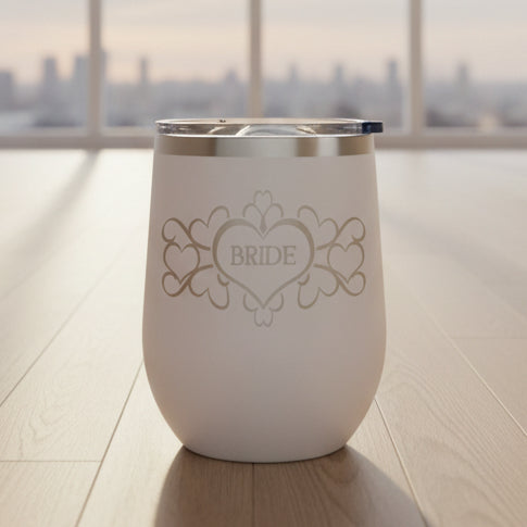 White wine tumbler with 'Bride' design on a wooden floor.